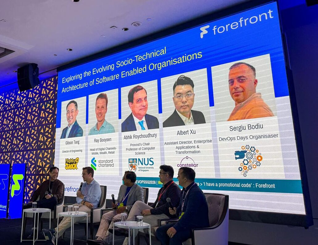 Gibson Tang and fellow panelists on stage at DevOps Summit Singapore 2026